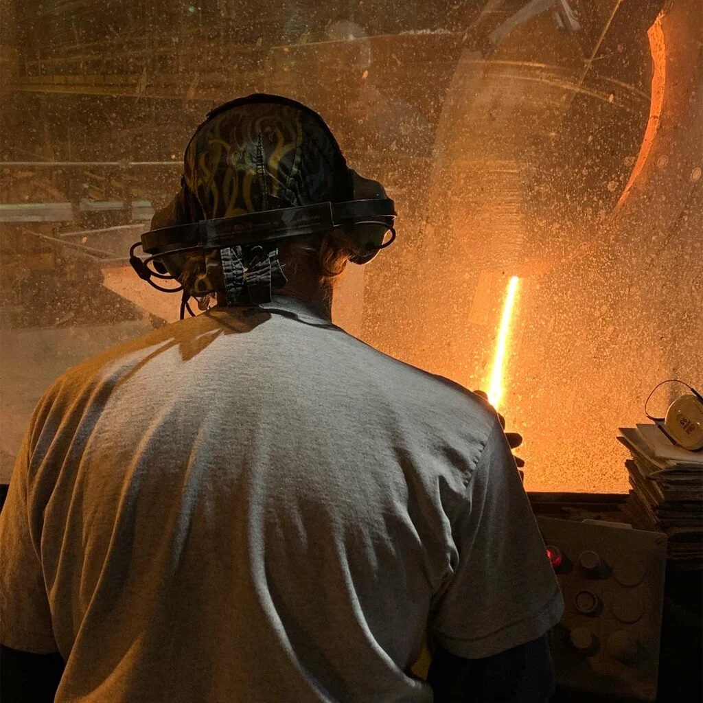 A view of steel beeing melted from an induction furnace operator station. 