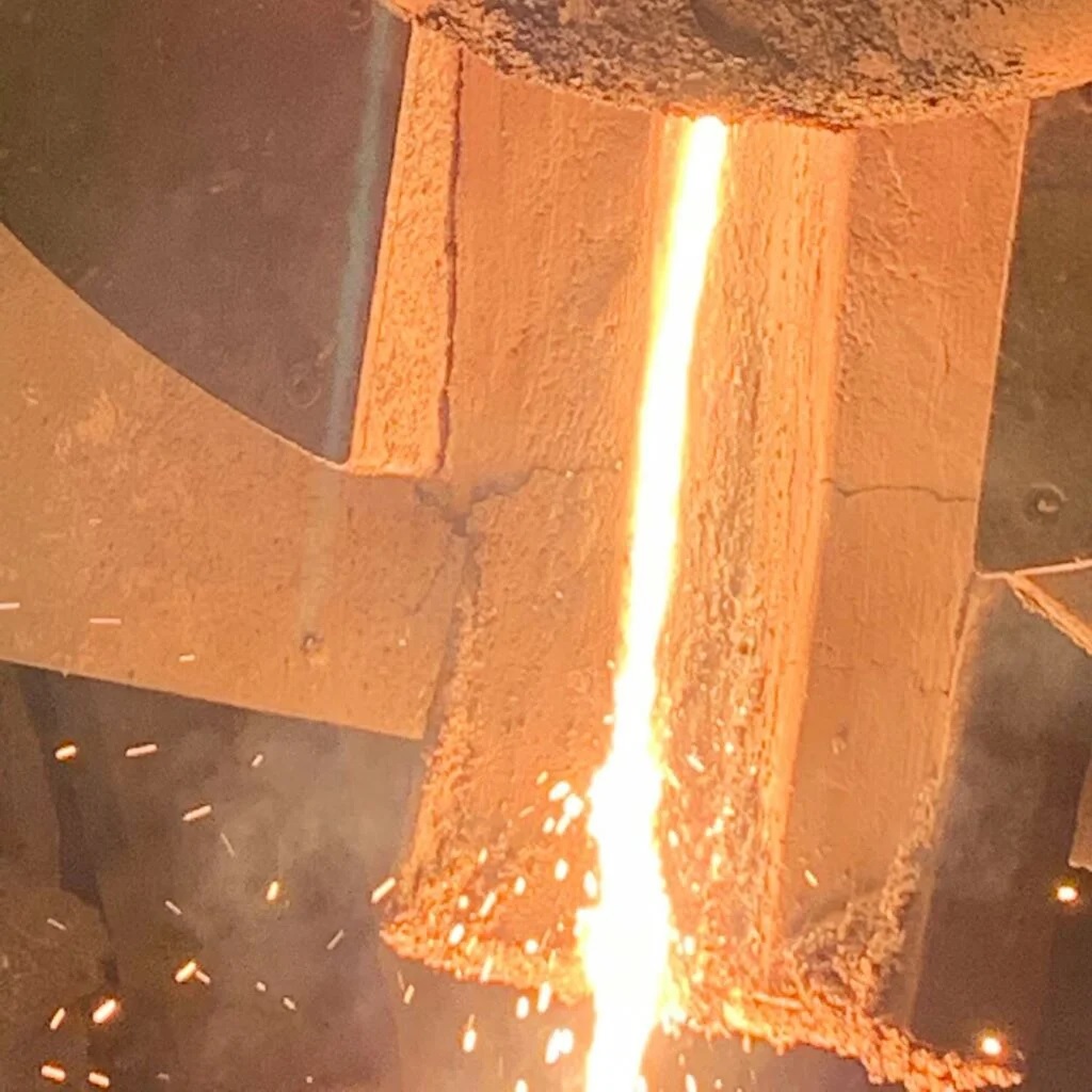 Molten metal being poured from the induction furnace.