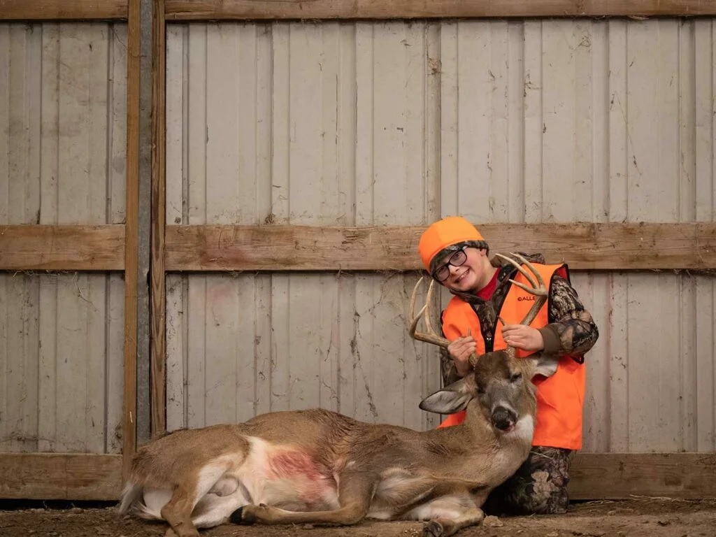 Nine-year-old Gryffin Raben shot his first buck from a folding chair tucked into tall grass. Cosmo Genova