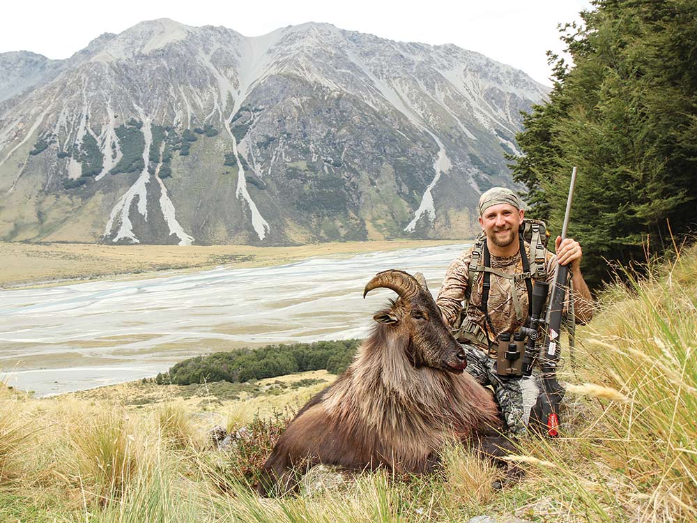 Bull Tahr, Mate: The author with his first tahr, a 12-inch bull. He used the trees in the background as cover for the stalk. Dan Rossiter